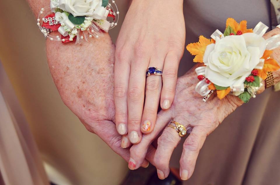 three generations of hands and corsages at a fall wedding