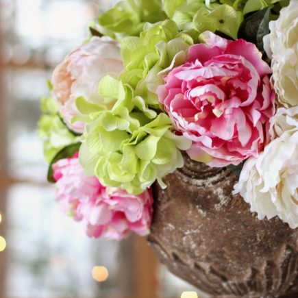 pink, green, and cream peonies and hydrangeas centerpiece at wedding reception