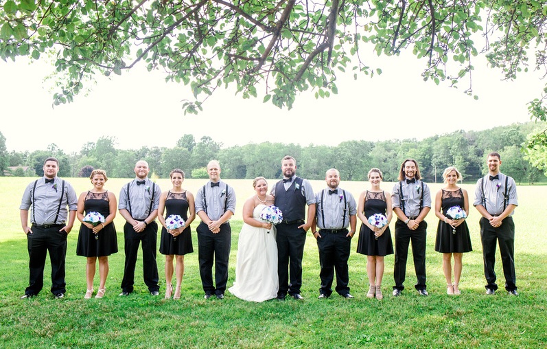 bridal party holding bouquet at foggy mountain wedding