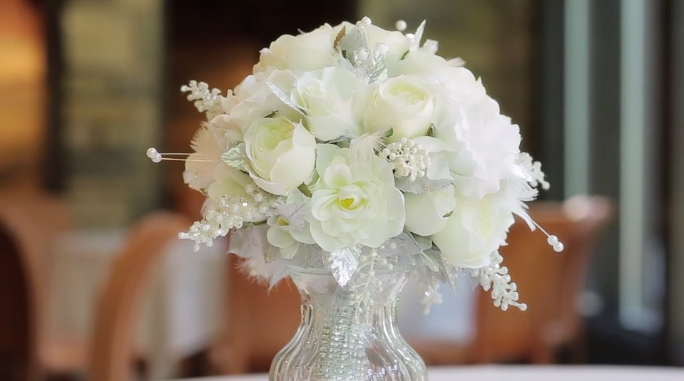 cream peony and rose wedding bouquet in a crystal vase