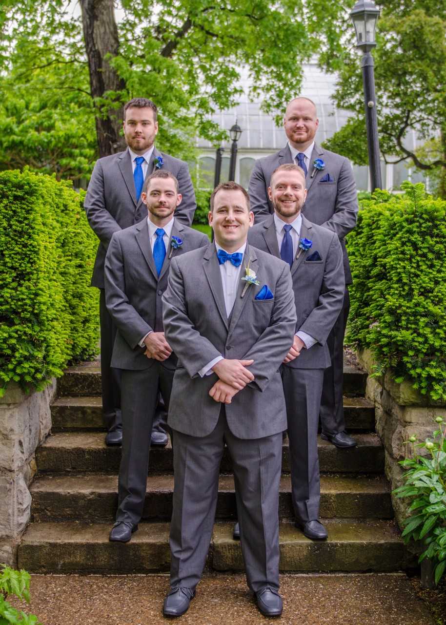 groom and groomsmen posed on the stairs at phipps conservatory