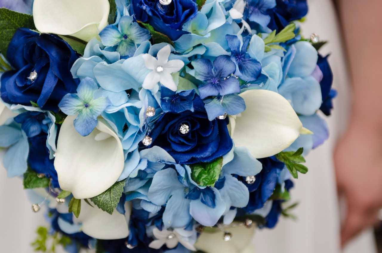 brides wedding bouquet of blue roses hydrangeascalla lilies