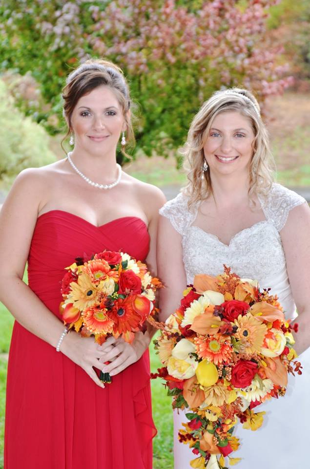 bride and bridesmaid show off bouquets during october wedding