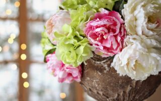 pink, green, and cream peonies and hydrangeas centerpiece at wedding reception