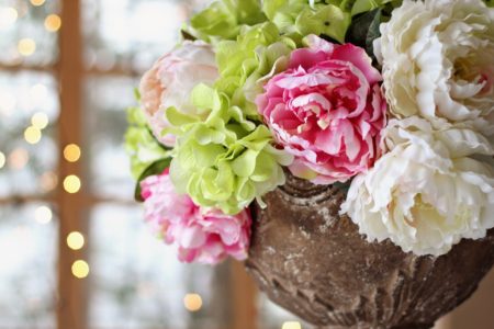 pink, green, and cream peonies and hydrangeas centerpiece at wedding reception